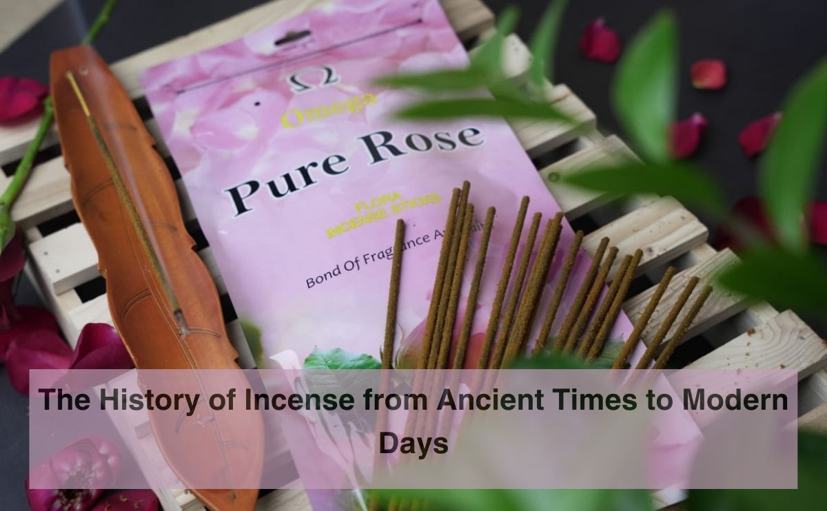 Rose incense sticks and wooden holder on a wooden pallet with pink Pure Rose incense packaging